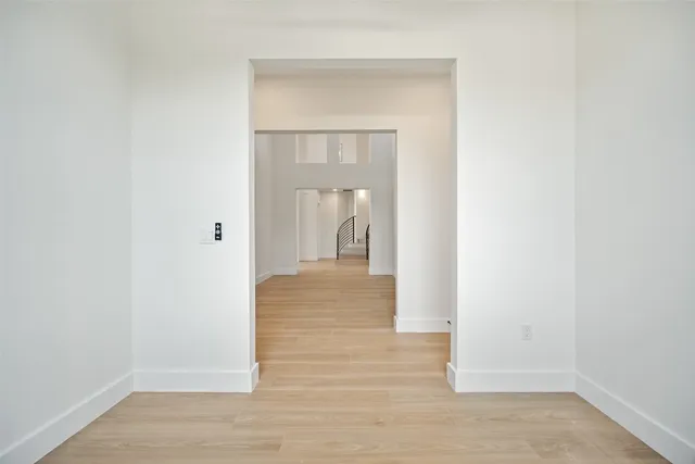 a large kitchen with stainless steel appliances granite countertop a large center island attached withe living room