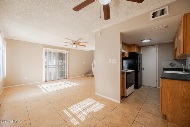 a view of a kitchen with a sink and a refrigerator