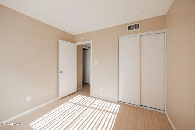 a view of a room with wooden floor