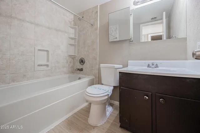 a bathroom with a sink toilet vanity and tub