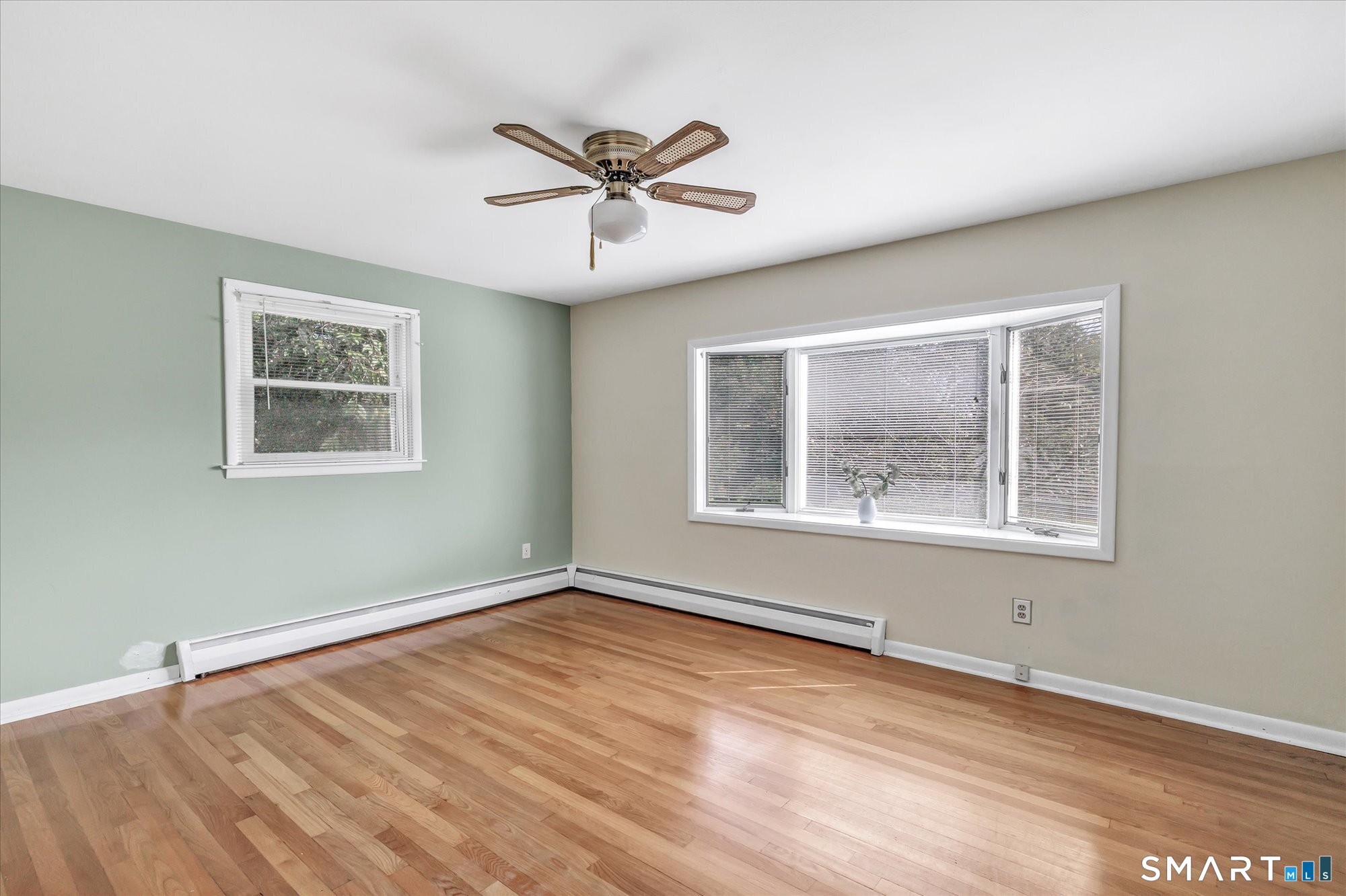 94 Ascolese Road Trumbull, CT 06611 - Photo 23 of 34 Main Level bedroom with hardwood floors and filled with natural light.