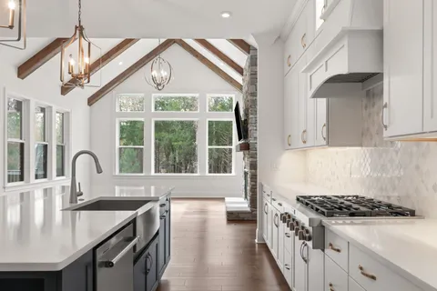 an empty room with windows and ceiling fan