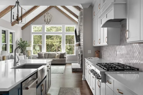 an aerial view of a house with a garden and lake view