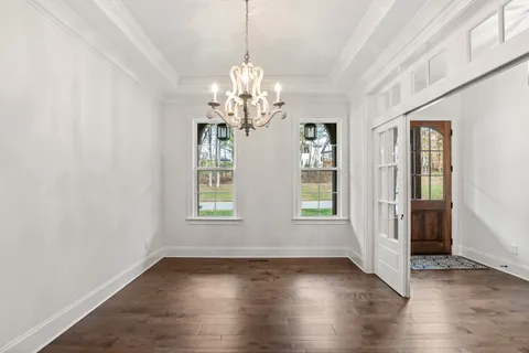 a view of a livingroom with a ceiling fan and window