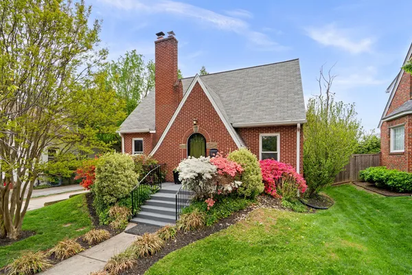 a front view of a house with a garden