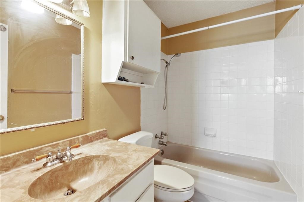 3000 Guadalupe Street, Unit 309 Austin, TX 78705 - Photo 3 of 5 a bathroom with a sink and a mirror