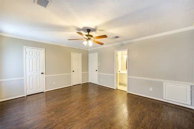 an empty room with wooden floor and window