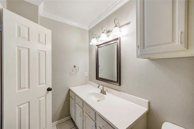 a bathroom with a sink vanity and a mirror
