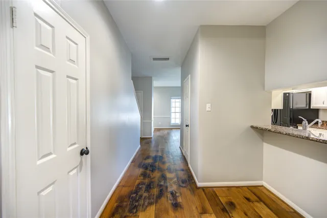 a view of hallway with wooden floor