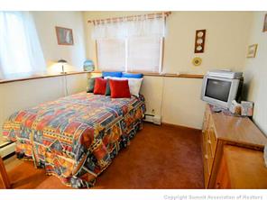 92 Alpine Road Dillon, CO 80435 - Photo 3 of 21 a bedroom with a bed and wooden floor