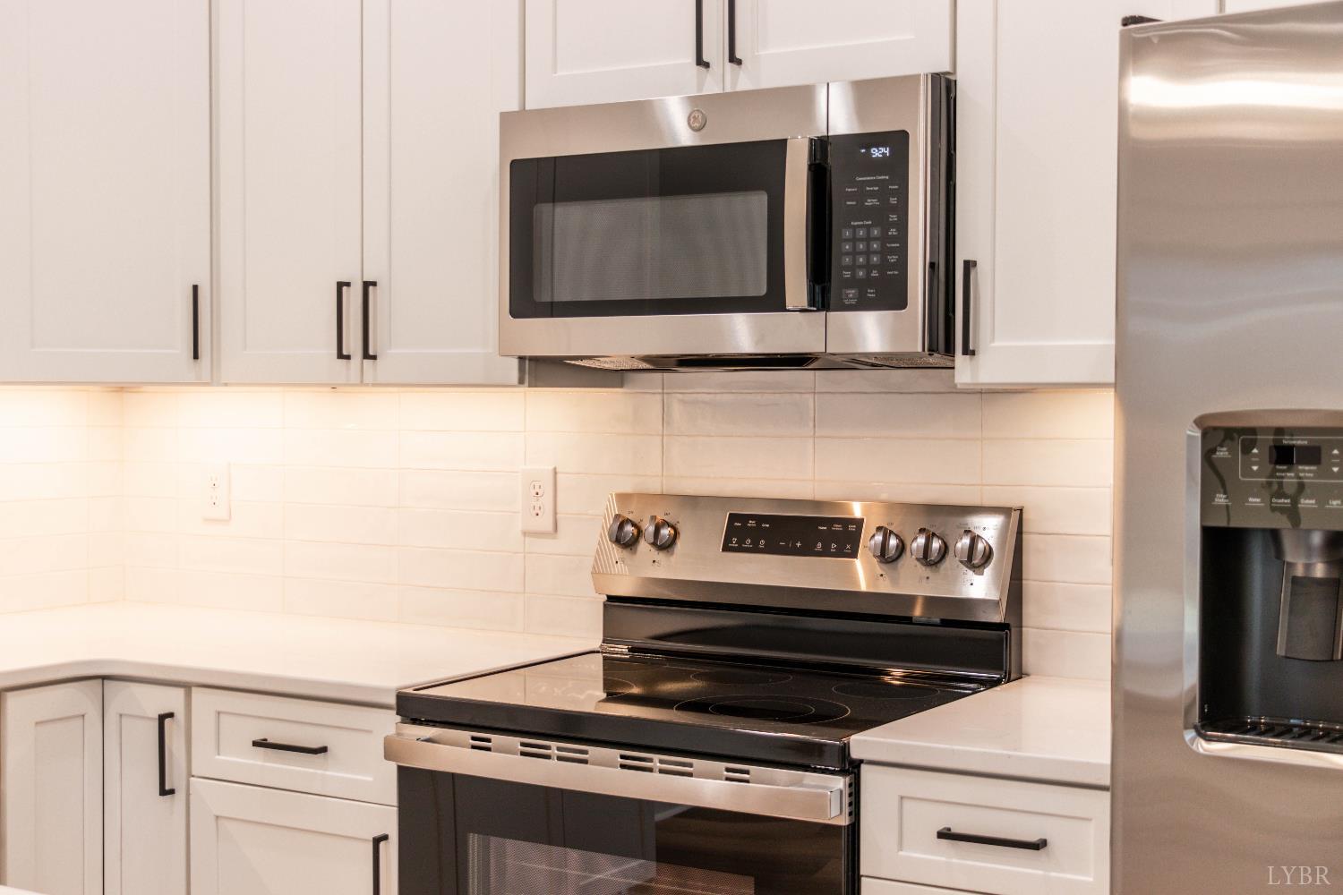 179 Luke Court Rustburg, VA 24588 - Photo 11 of 53 a kitchen with granite countertop a stove and a microwave