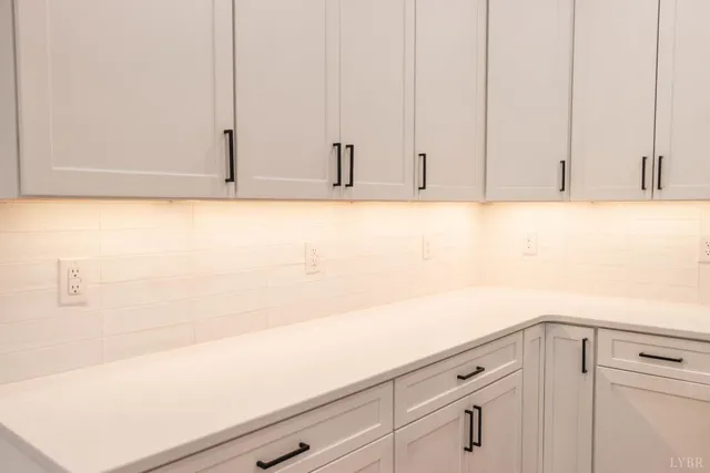 a view of kitchen with cabinets