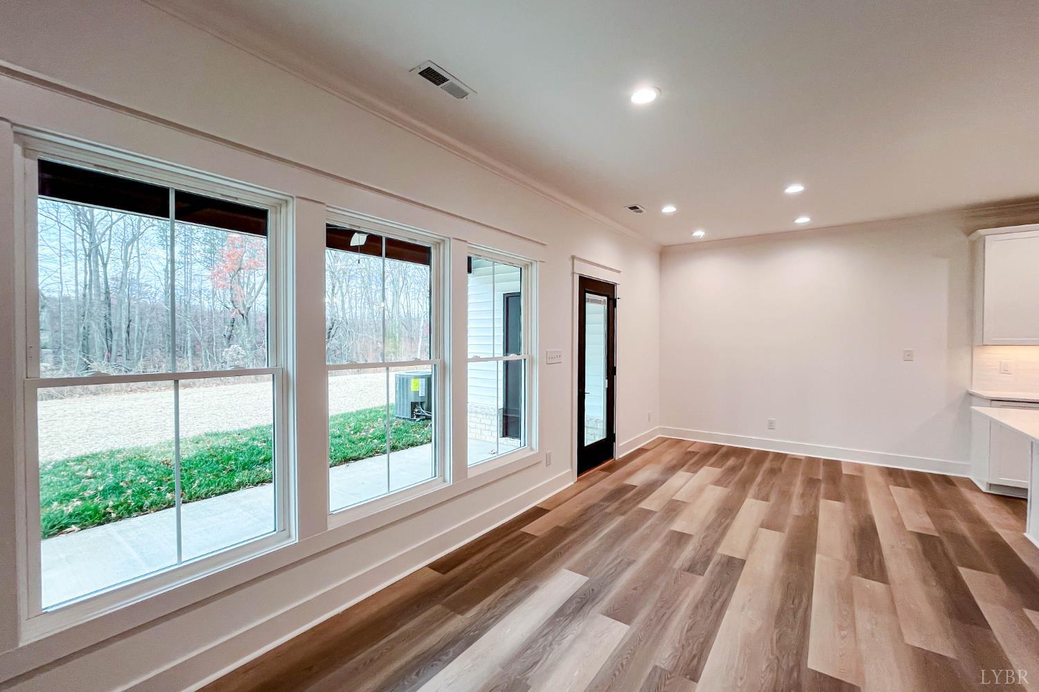 179 Luke Court Rustburg, VA 24588 - Photo 19 of 53 a view of an empty room with wooden floor and a window