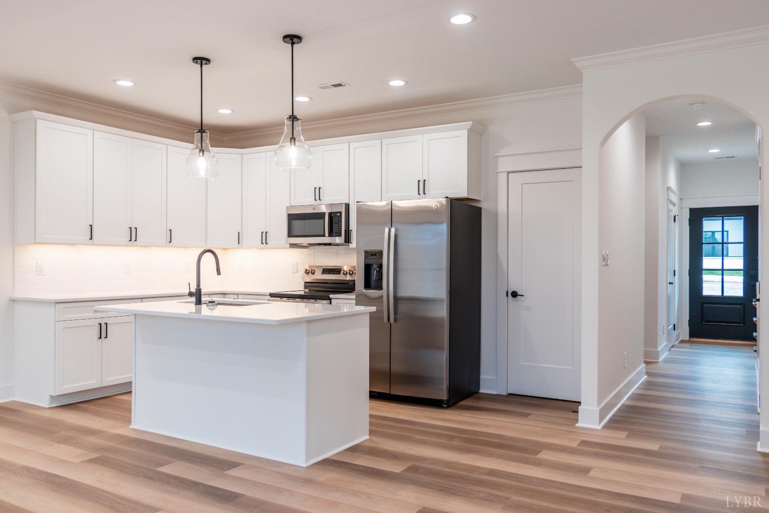 179 Luke Court Rustburg, VA 24588 - Photo 7 of 53 a kitchen with stainless steel appliances granite countertop a refrigerator a sink dishwasher a stove and white cabinets with wooden floor