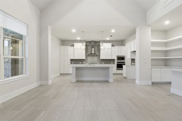 a large kitchen with a sink and cabinets