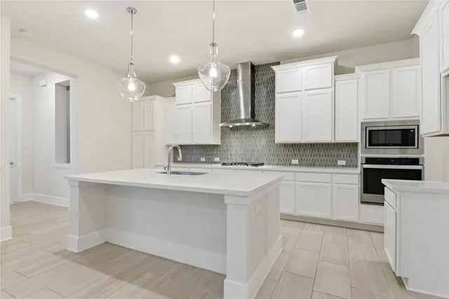 a kitchen with stainless steel appliances a sink stove and cabinets