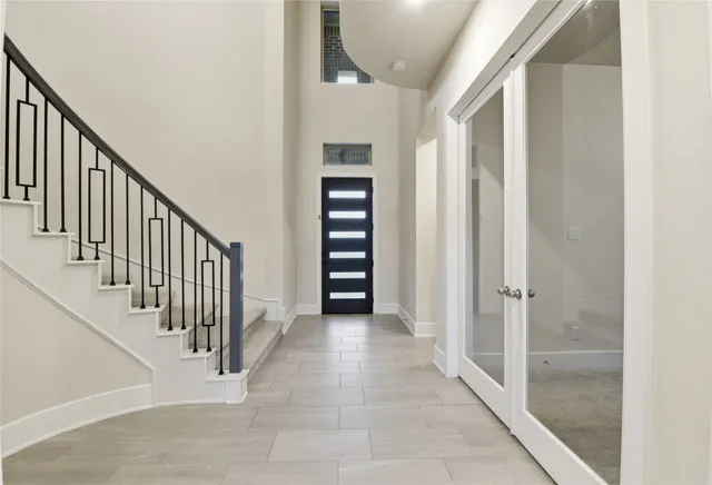 a view of a hallway with wooden floor and entryway
