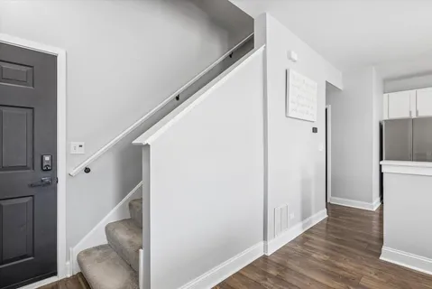 a view of entryway and hall with wooden floor