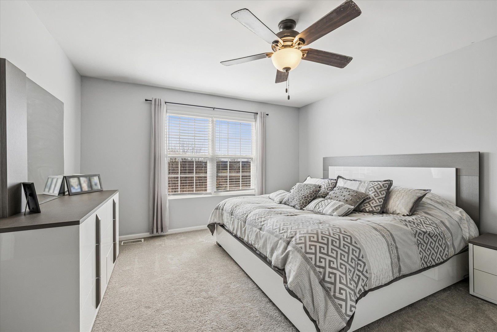 16224 Golf View Drive Lockport, IL 60441 - Photo 15 of 21 a bedroom with a large bed chandelier and a window