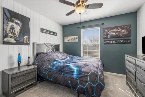 a bedroom with a bed and a chandelier