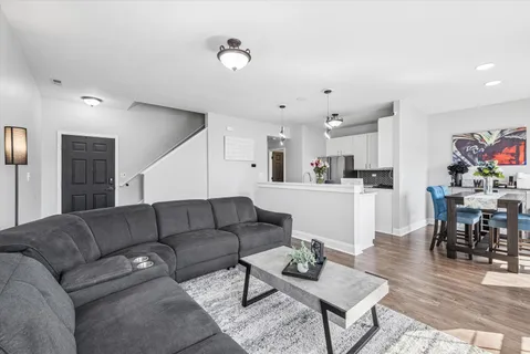 a living room with furniture and kitchen view