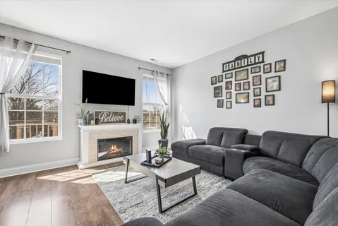 a living room with furniture a fireplace and a flat screen tv