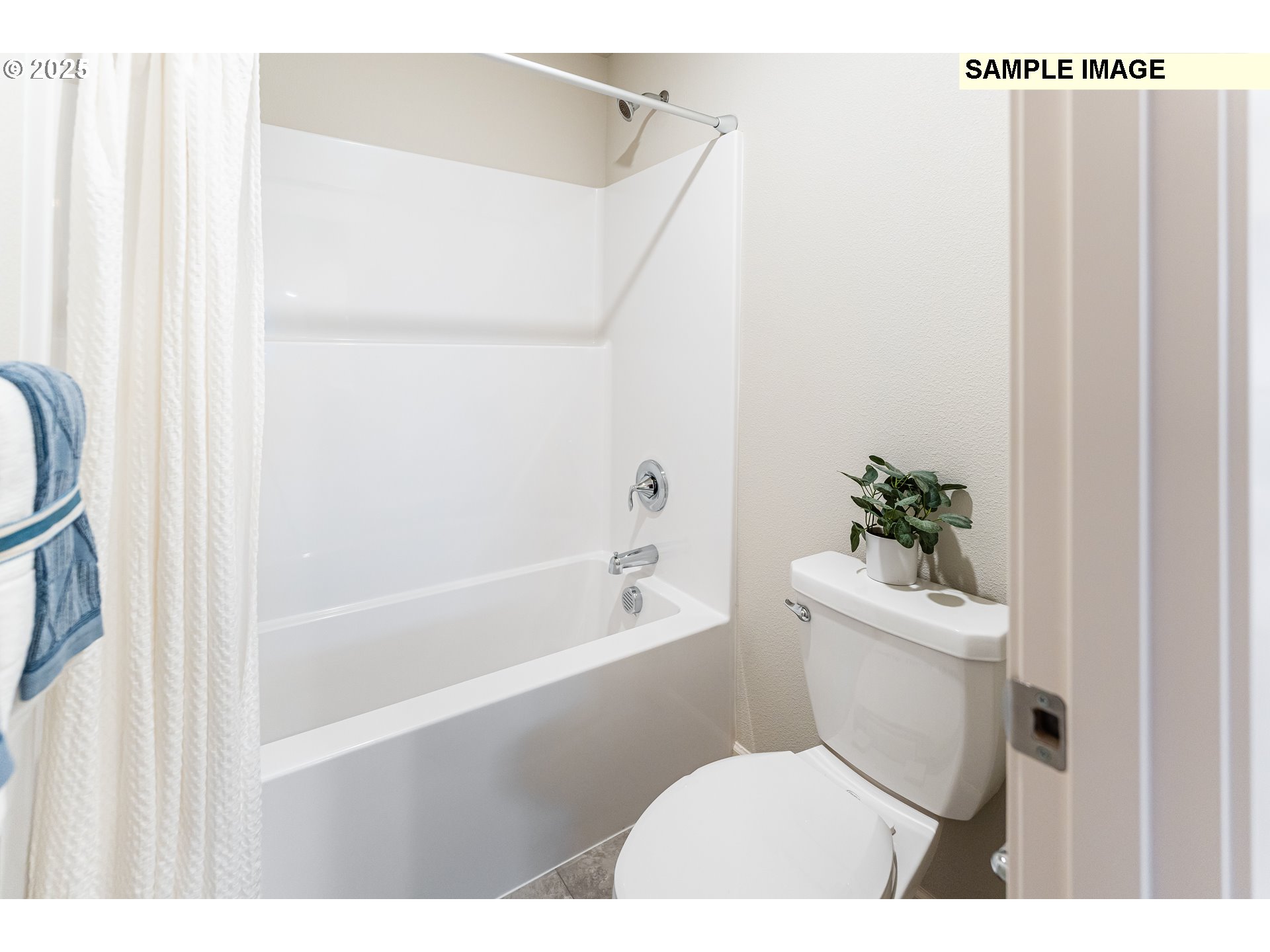 8921 Southwest Choke Cherry Tualatin, OR 97062 - Photo 12 of 28 a bathroom with a toilet a sink and a bathtub