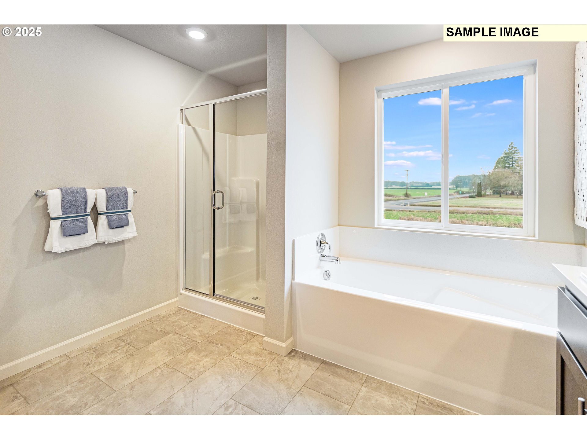8921 Southwest Choke Cherry Tualatin, OR 97062 - Photo 25 of 28 a bathroom with a bathtub and a shower