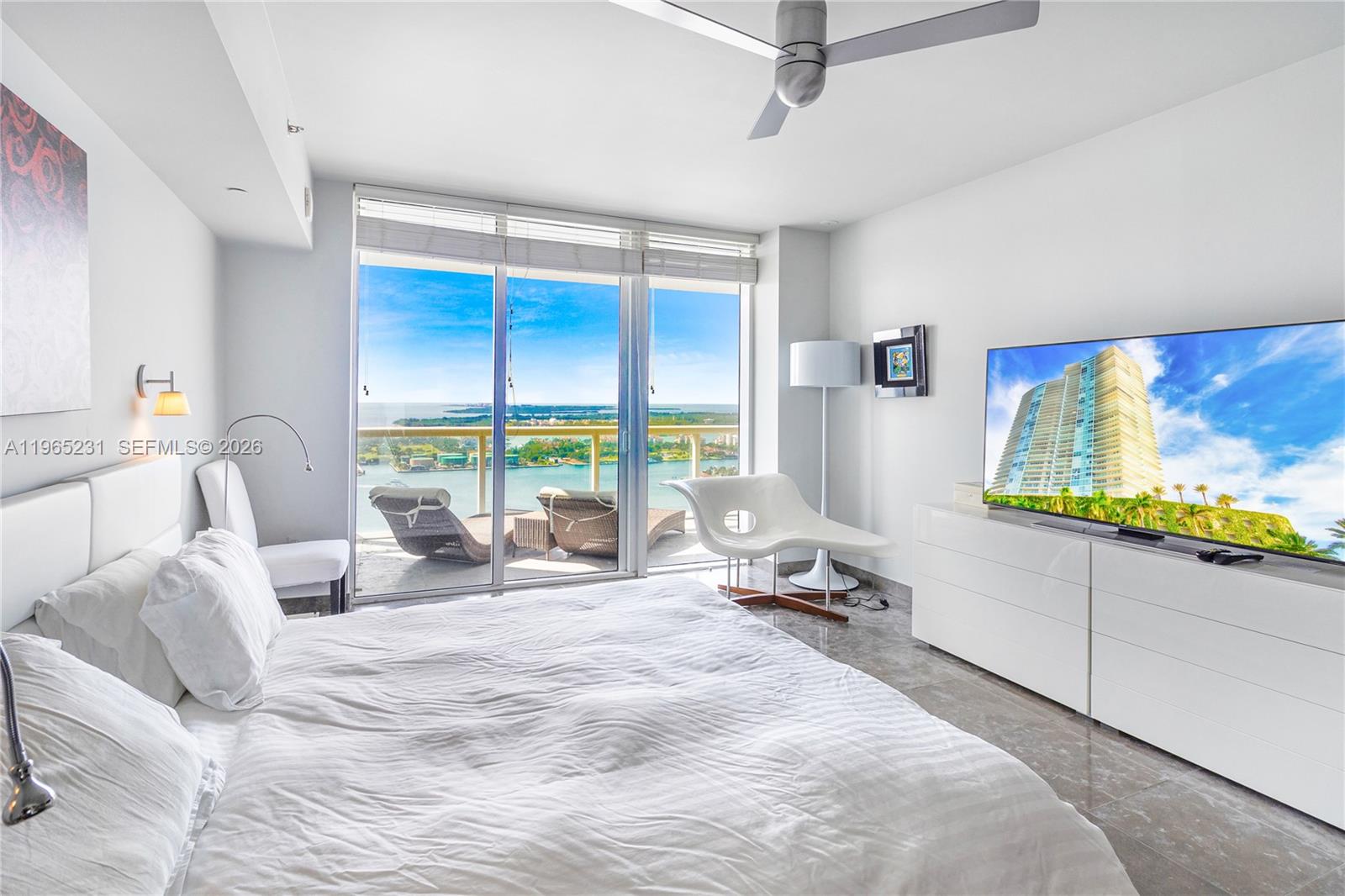 450 Alton Road, Unit 3703 Miami Beach, FL 33139 - Photo 11 of 27 a room with bed and large window
