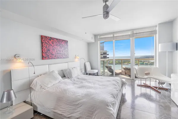 a bed room with a bed and a large window