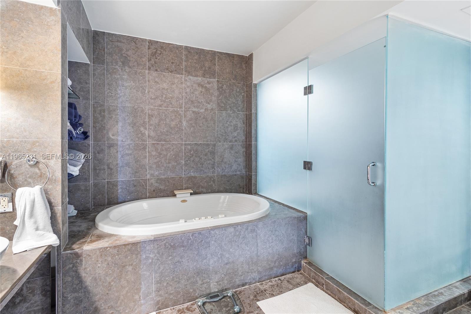 450 Alton Road, Unit 3703 Miami Beach, FL 33139 - Photo 14 of 27 a bathroom with a bathtub and shower