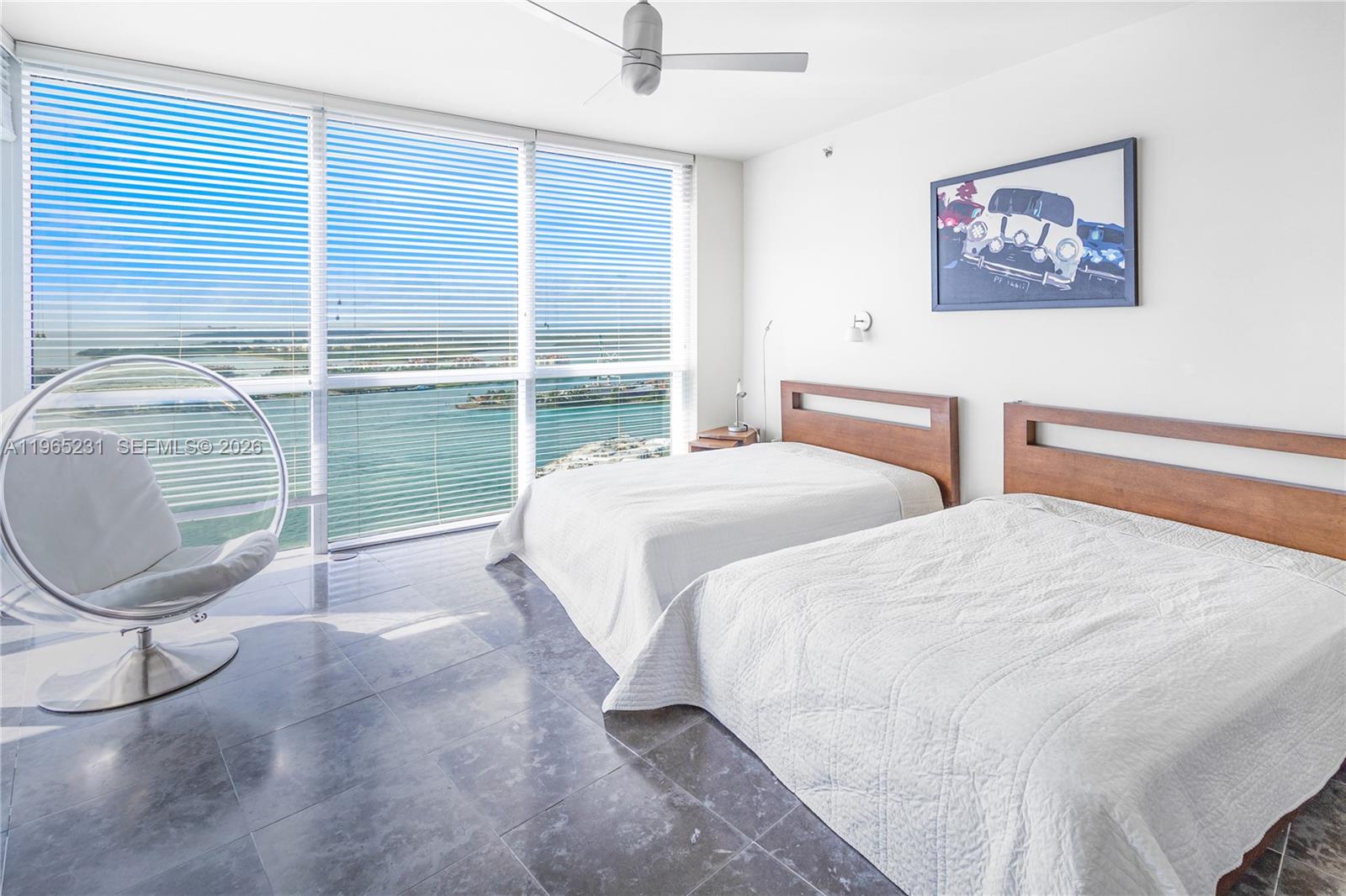 450 Alton Road, Unit 3703 Miami Beach, FL 33139 - Photo 18 of 27 a bedroom with two beds and a large window