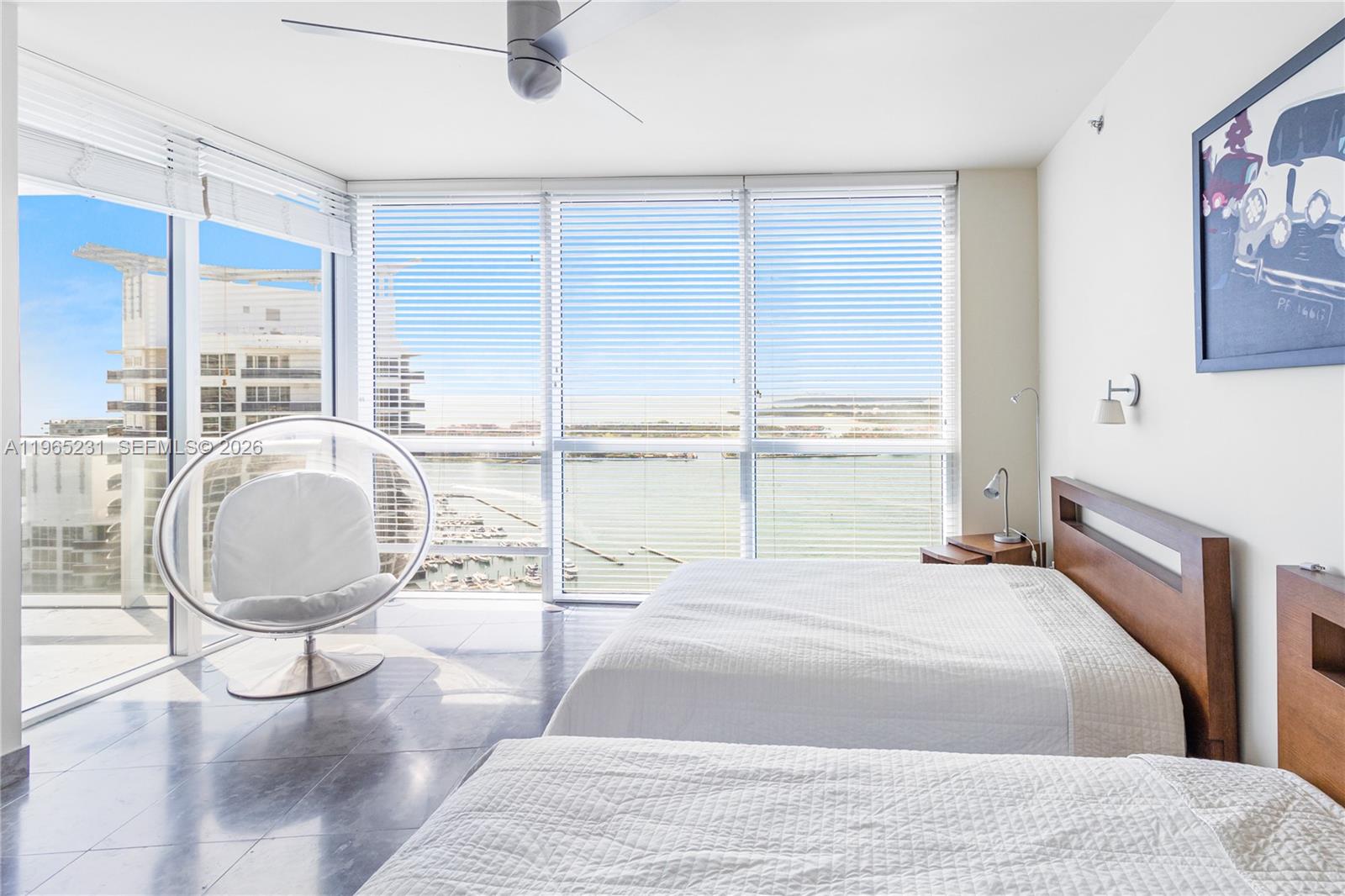 450 Alton Road, Unit 3703 Miami Beach, FL 33139 - Photo 19 of 27 a room with a bed a table and chair