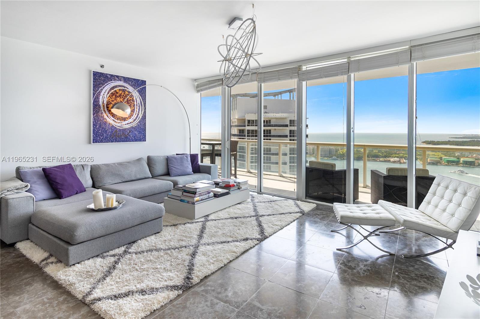 450 Alton Road, Unit 3703 Miami Beach, FL 33139 - Photo 2 of 27 a living room with furniture and a floor to ceiling window