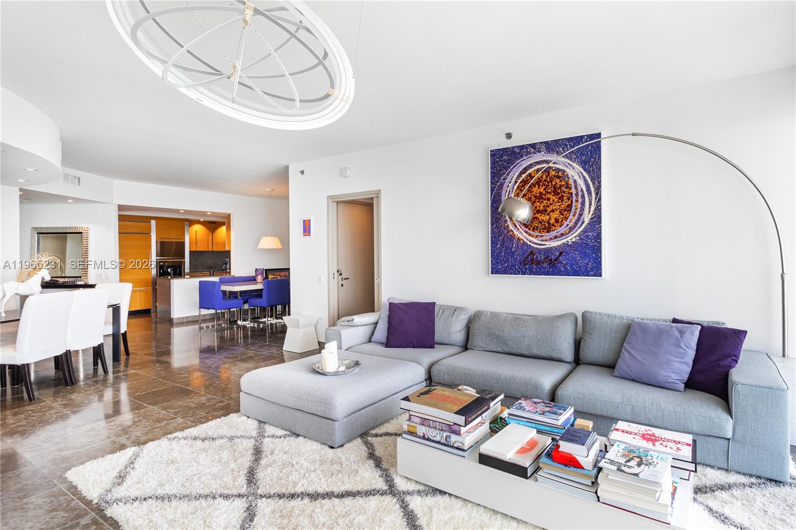 450 Alton Road, Unit 3703 Miami Beach, FL 33139 - Photo 3 of 27 a living room with furniture and a dining table with wooden floor