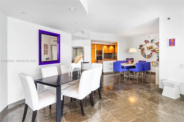 a living room with furniture and a dining table
