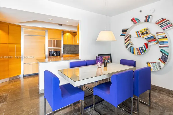 a view of a dining room with furniture and a large window