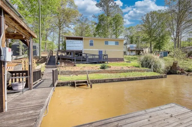 a view of a swimming pool with outdoor seating and plants