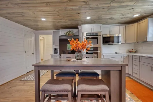 a kitchen with stainless steel appliances wooden cabinets and a stove top oven
