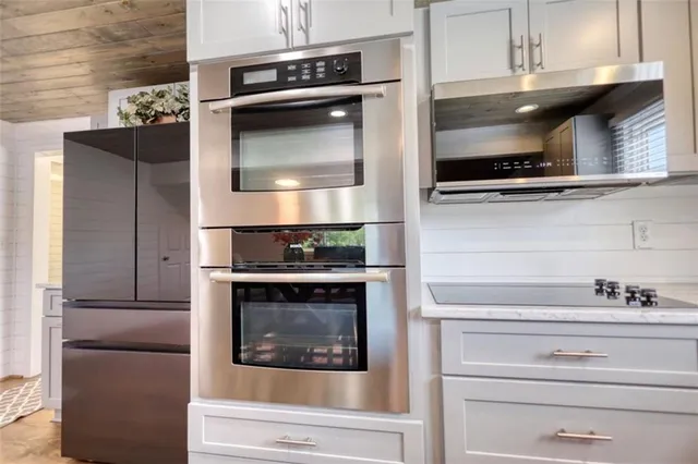 a bathroom with a toilet sink vanity and mirror