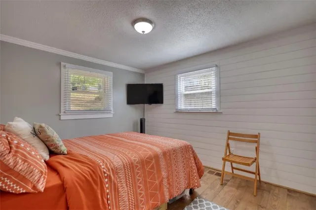 a bedroom with a large bed and a chandelier