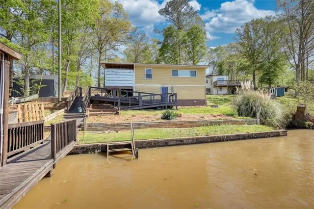 a view of house with swimming pool and sitting area