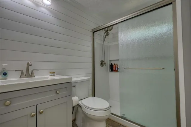 a bathroom with a toilet and a shower