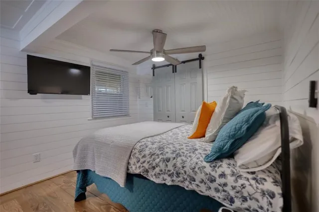 a bedroom with a bed and wooden floor