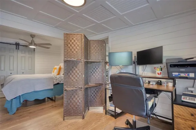 a view of a workspace with furniture and a window