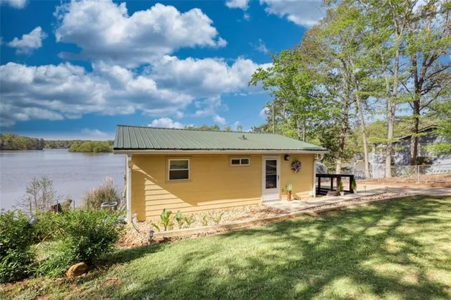 a view of a patio with couches chairs and a table with potted plants