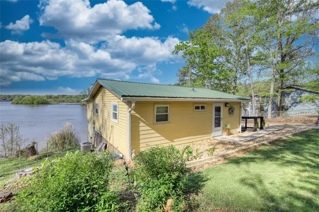 a view of a balcony with dining area and wooden floor