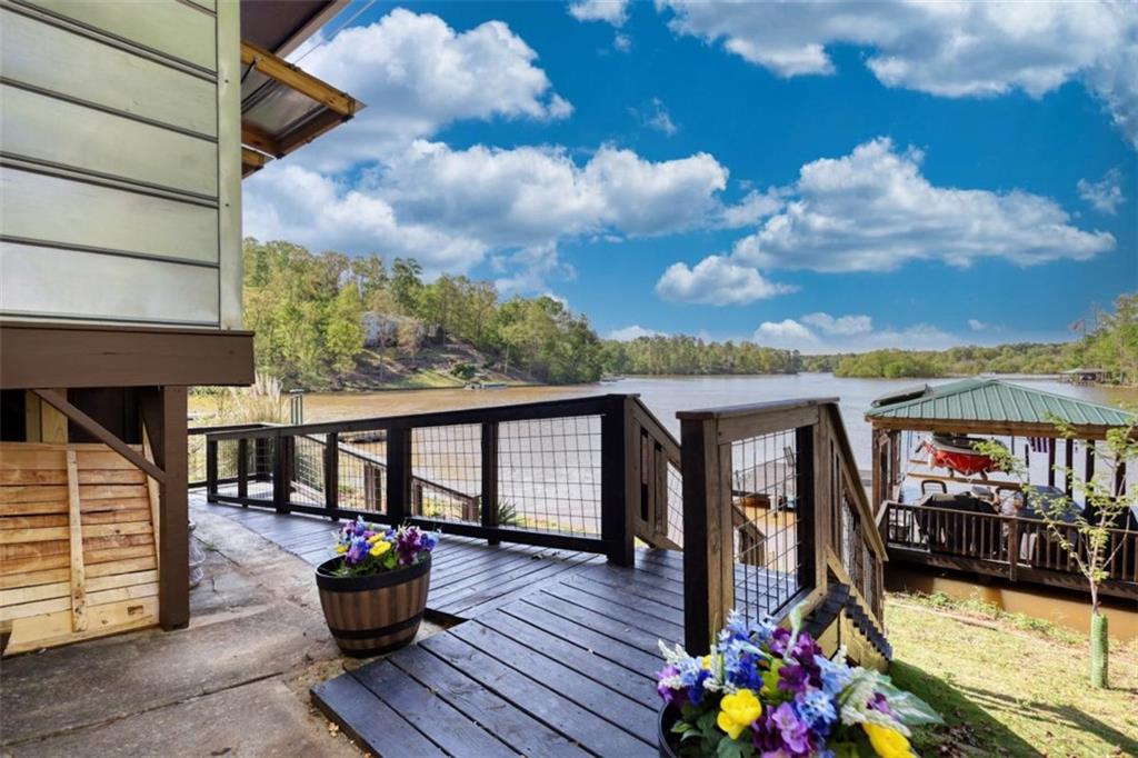 480 Friar Tuck Circle Covington, GA 30014 - Photo 42 of 56 a view of a balcony with dining area and wooden floor