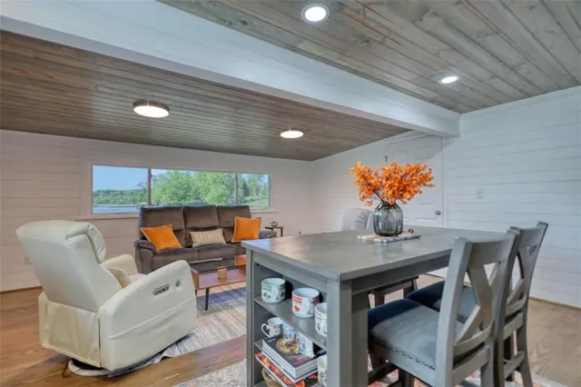 a living room with furniture kitchen view and a flat screen tv