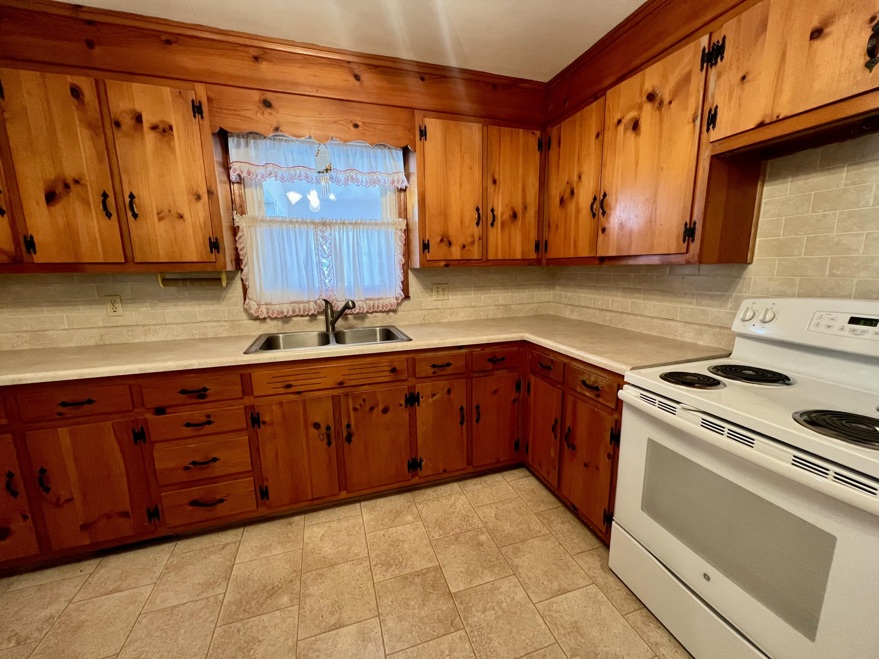 307 Virginia Mineral Springs Road New Castle, VA 24127 - Photo 7 of 45 a kitchen with wooden cabinets and a stove top oven